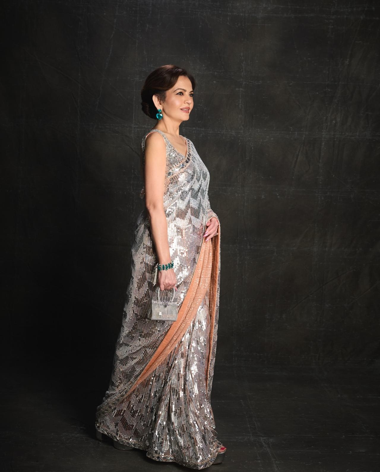 Nita Ambani made heads turn in Manish Malhotra's luminous silver sequin saree featuring chevron detailing and an intricately structured drape. The outfit blended modern sophistication with heritage couture.